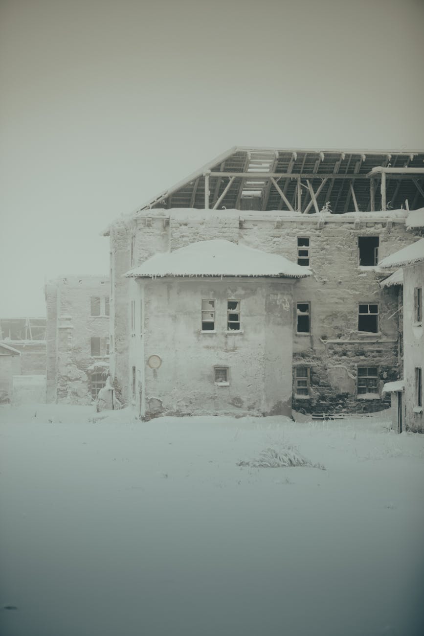 A lone baker stands in the center of a deserted town square, his makeshift bakery set up beside him, the aroma of baking bread wafting through the empty streets.
