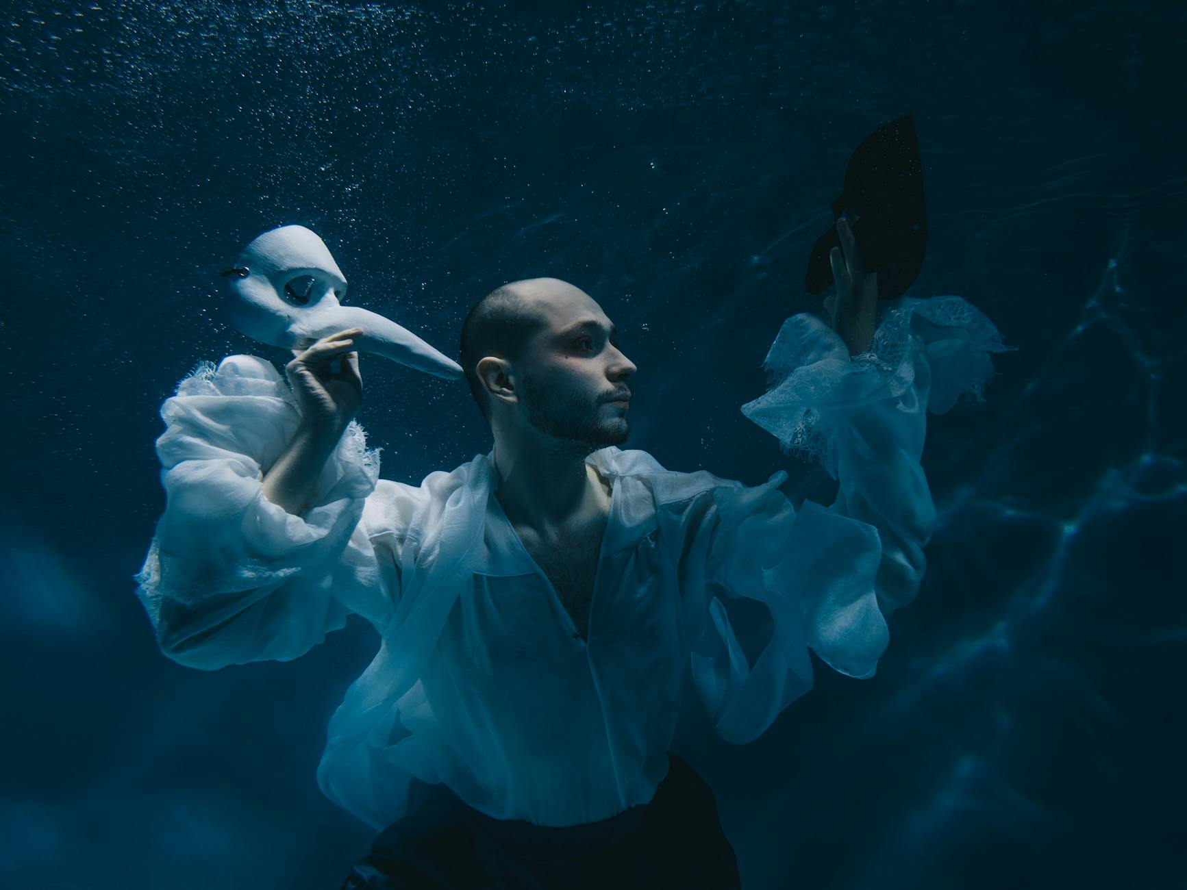 A fantastical underwater city shimmering with ethereal light, surrounded by luminous fish and otherworldly creatures.