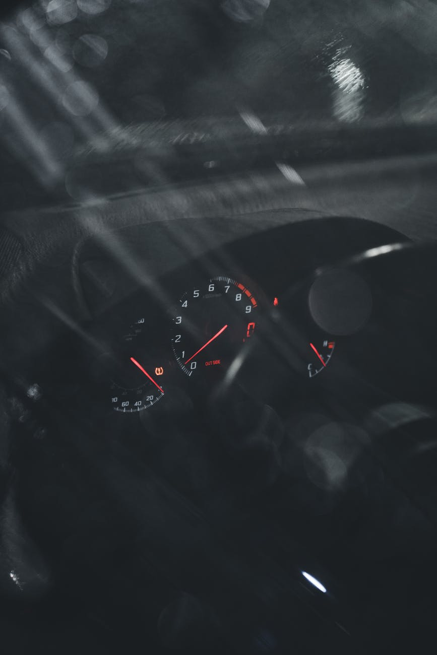 A cozy, isolated cabin nestled in the mountains, glowing warmly against the dark backdrop of the night sky.