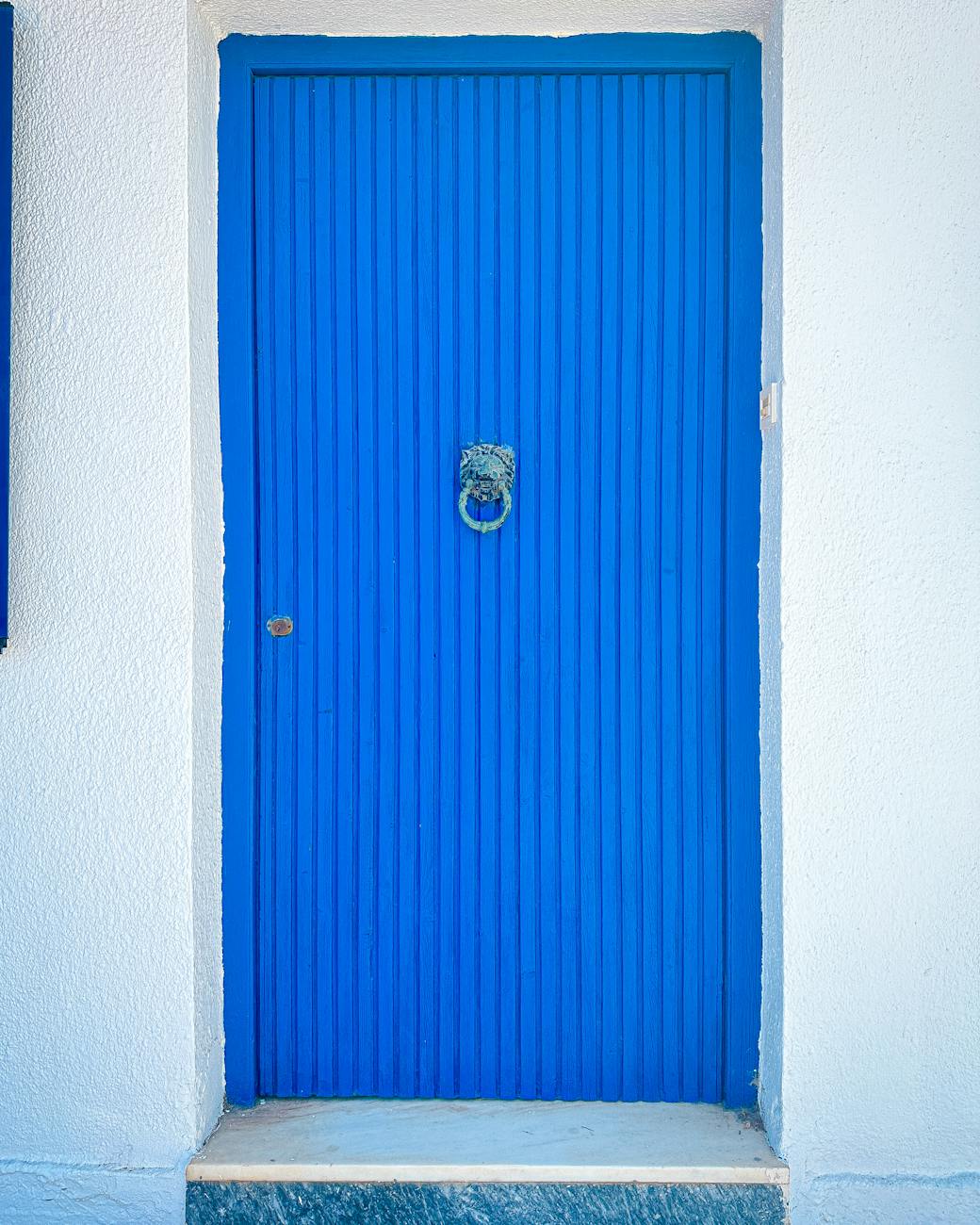 A vibrant Greek village festival with stalls and people celebrating.