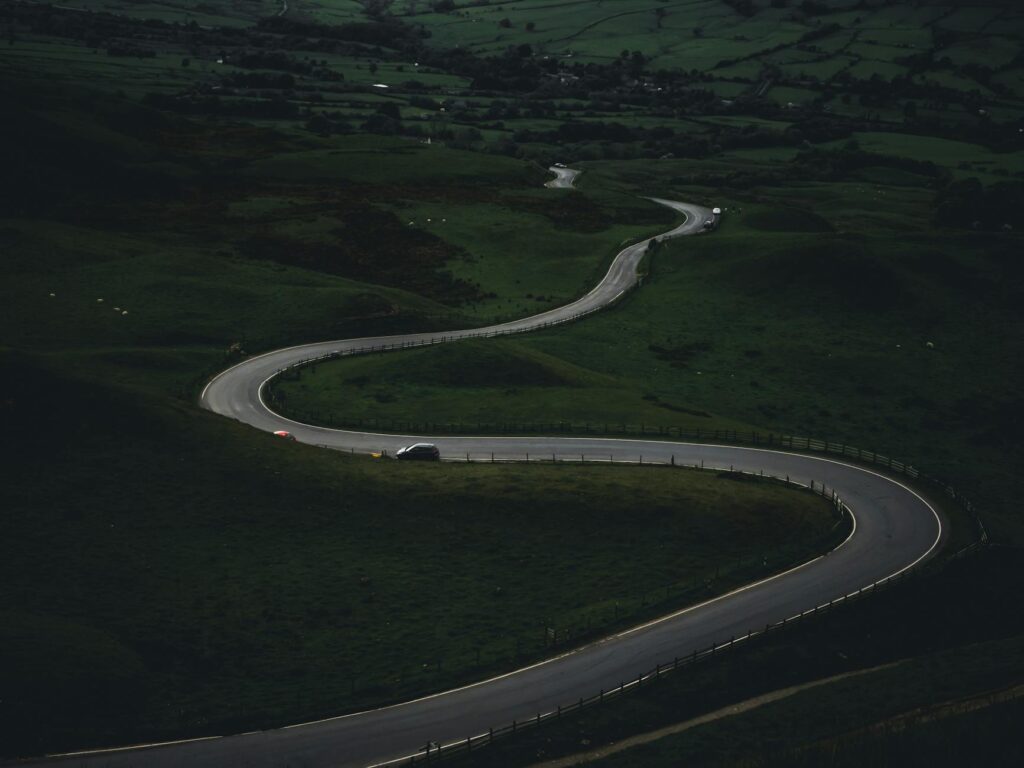 A serene valley bathed in the soft glow of twilight, with numerous wind chimes hanging from trees, creating a peaceful and ethereal atmosphere.
