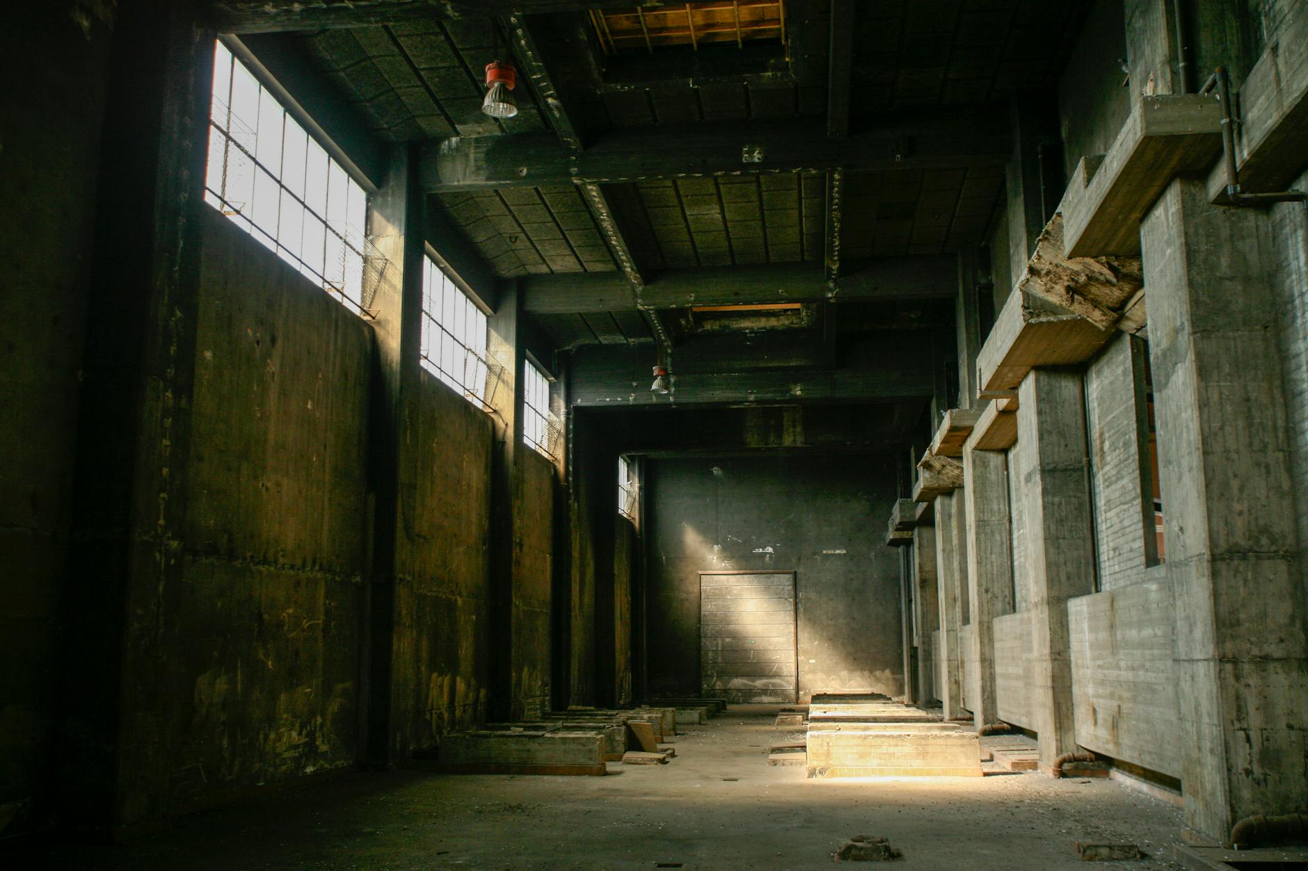 An abandoned theatre interior bathed in moonlight, dust motes dancing in the air.