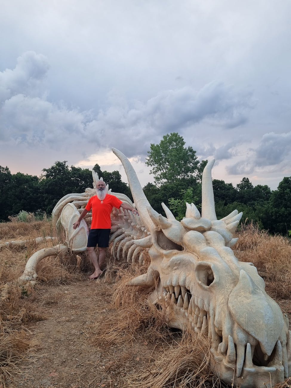 A giant, reflective eye dominates the night sky, casting an ethereal glow on the landscape below.