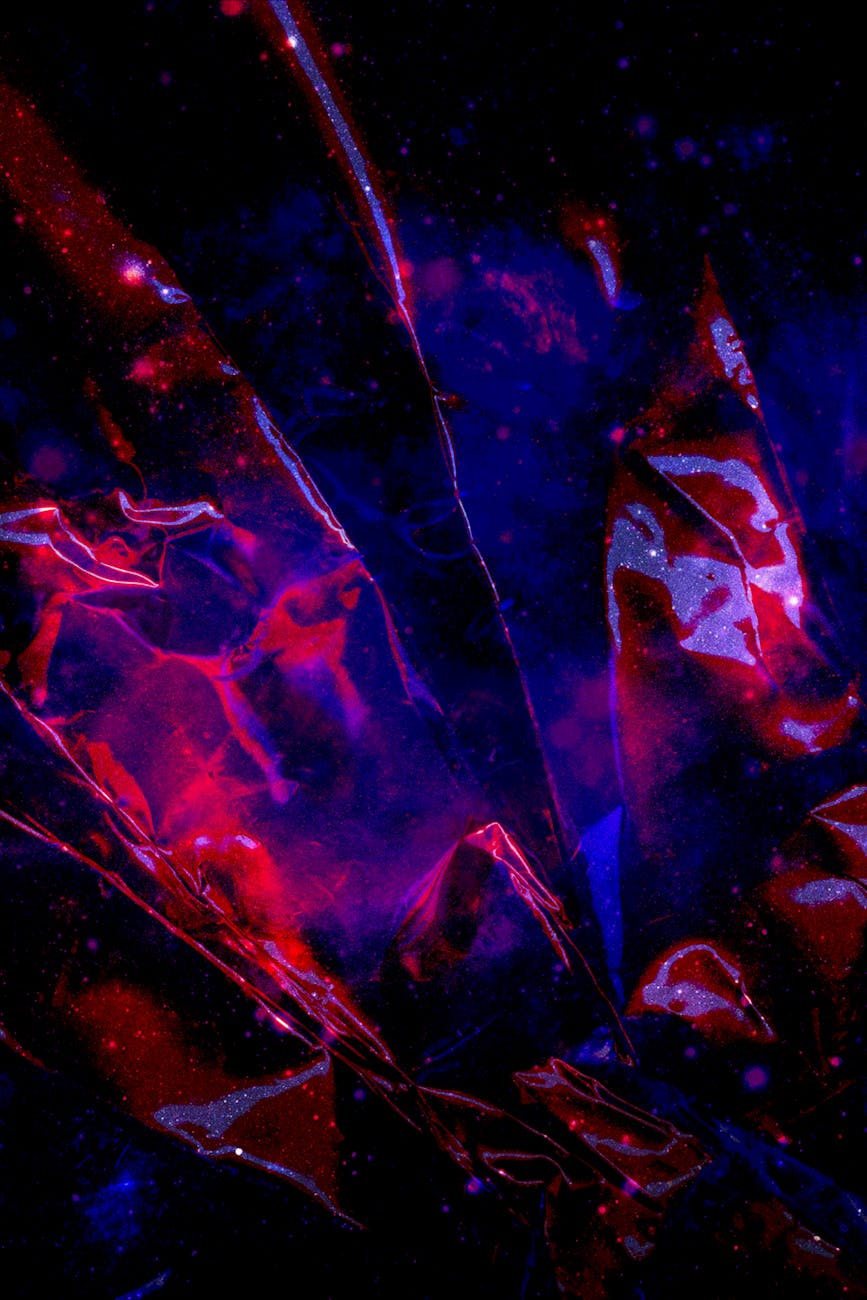 Abstract image of broken glass shards reflecting light, symbolizing the fragmented nature of heartbreak and the potential for light to emerge from brokenness.