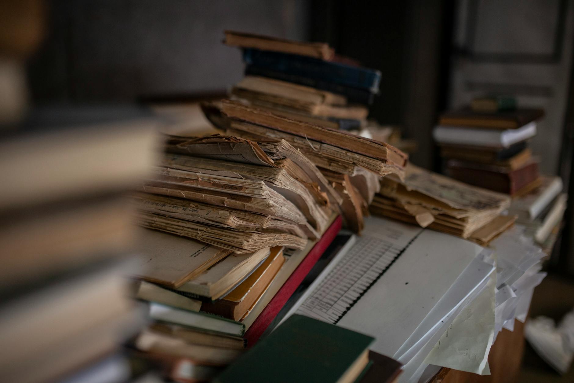 A dusty, dimly lit archive filled with rows of ancient books and artifacts, evoking a sense of forgotten history.