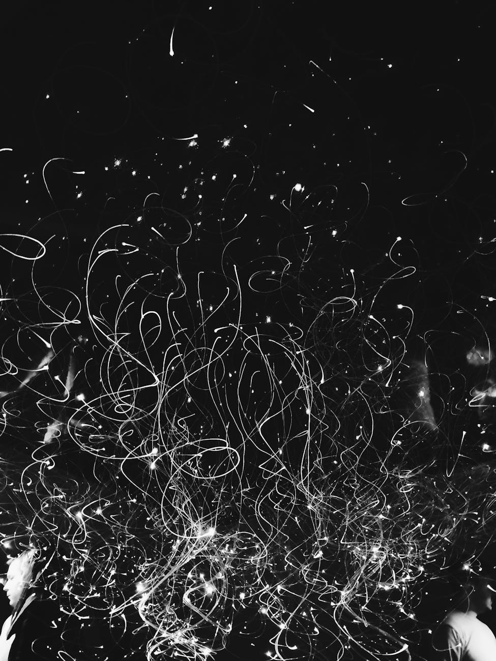 An abstract representation of a storm's darkness with a small light representing hope and kindness.